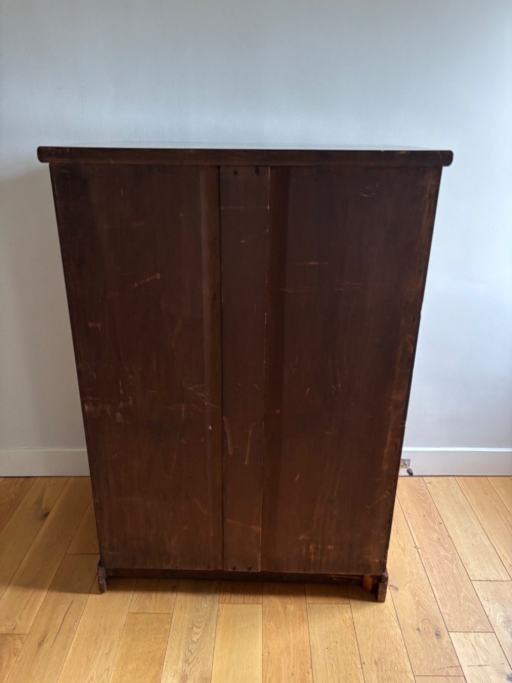 A mid-Victorian mahogany chest of drawers featuring four full-width drawers with turned wooden knobs set on a continuous plinth base. View V