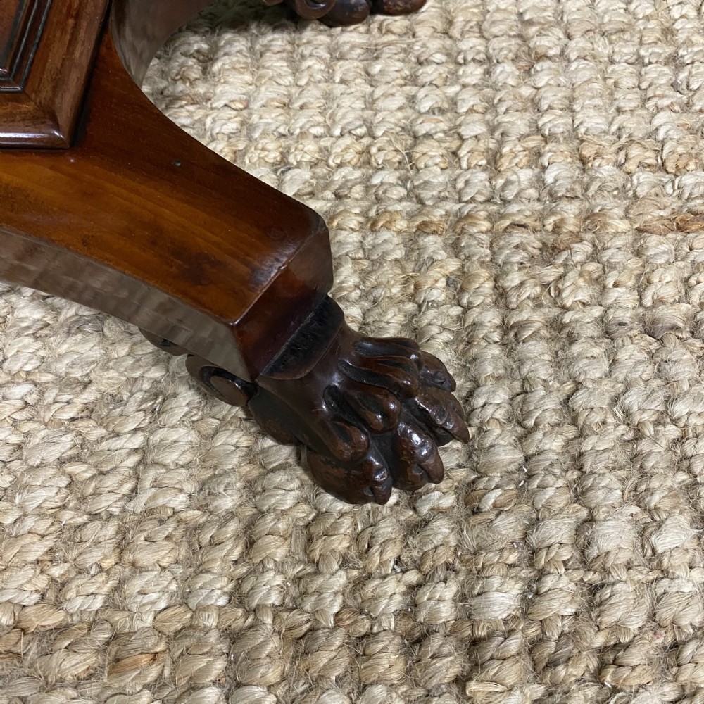 A William IV flame mahogany work table featuring a top drawer, pleated fabric work basket, U-shaped pedestal support, and carved claw feet. View II