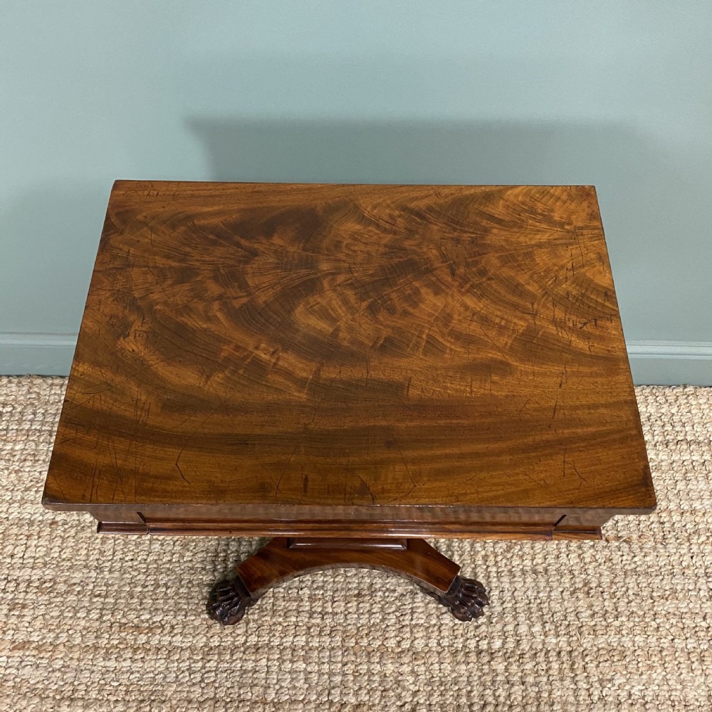A William IV flame mahogany work table featuring a top drawer, pleated fabric work basket, U-shaped pedestal support, and carved claw feet. View VI