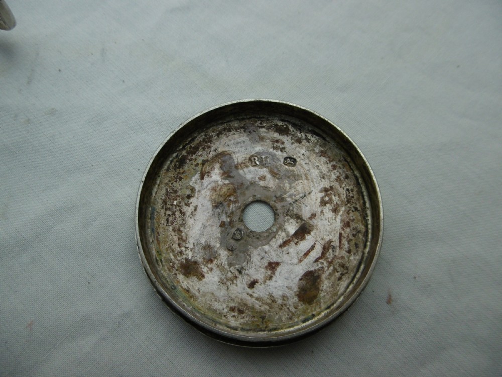 A small cylindrical Georgian sterling silver bougie box with a side loop handle and a circular hole in the lid. View IV