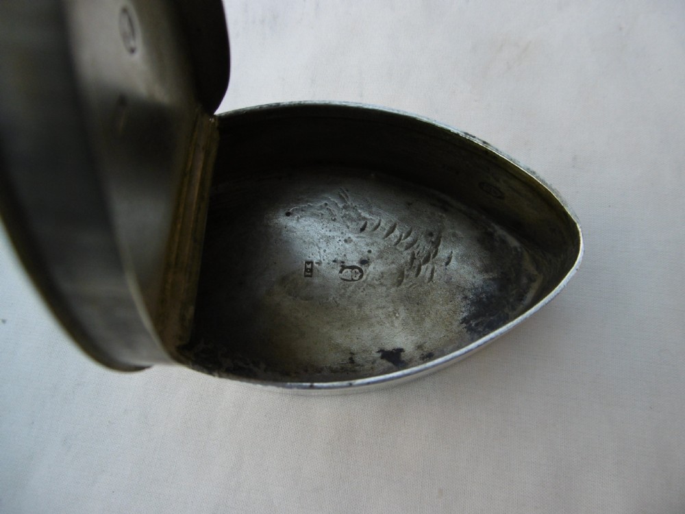 An 18th-century navette-shaped sterling silver snuff box featuring bright-cut engraved borders and a central oval cartouche. View IV