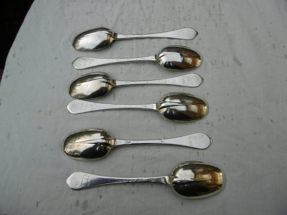 A set of six 1706 Queen Anne sterling silver dognose tablespoons arranged inside a velvet-lined wooden case. View II