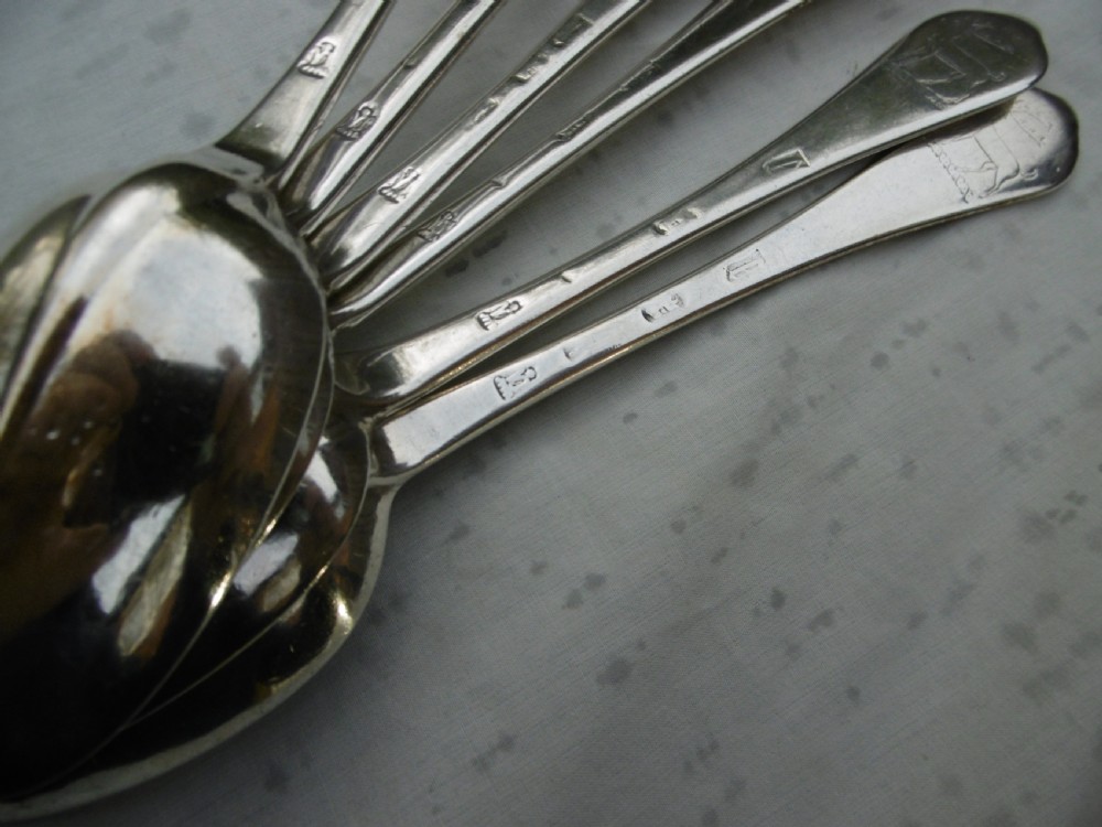 A set of six 1706 Queen Anne sterling silver dognose tablespoons arranged inside a velvet-lined wooden case. View IV