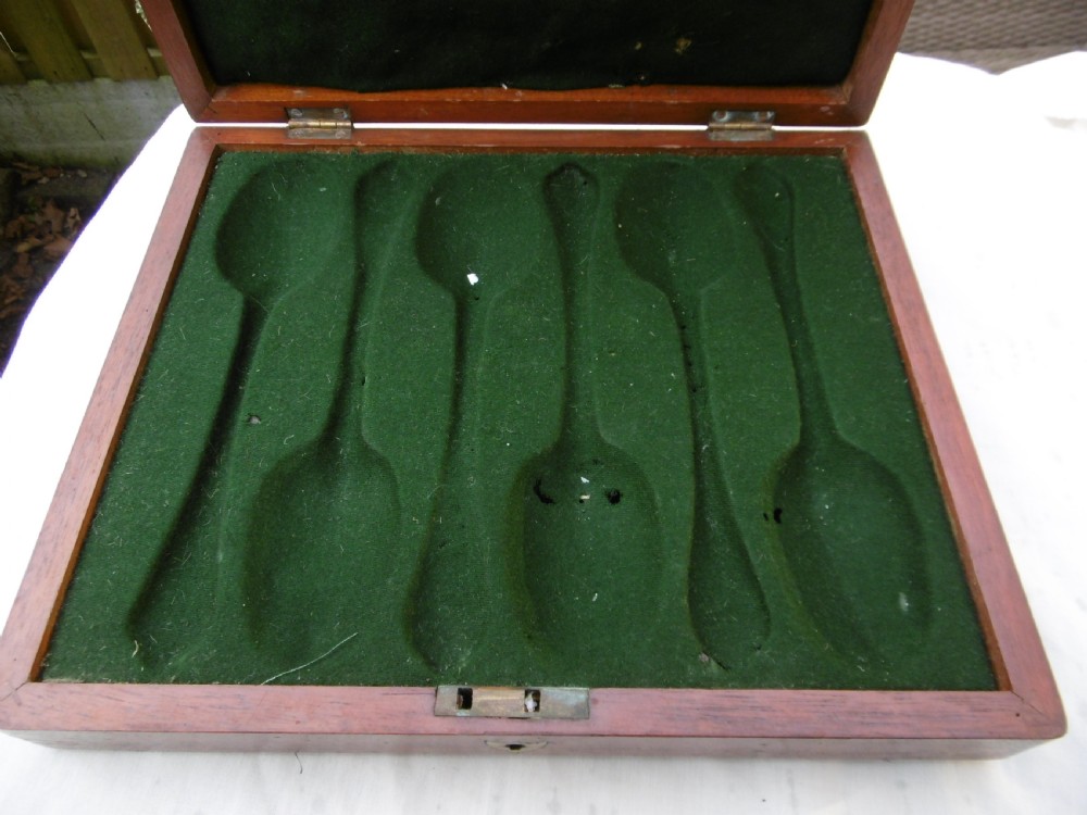 A set of six 1706 Queen Anne sterling silver dognose tablespoons arranged inside a velvet-lined wooden case. View VII