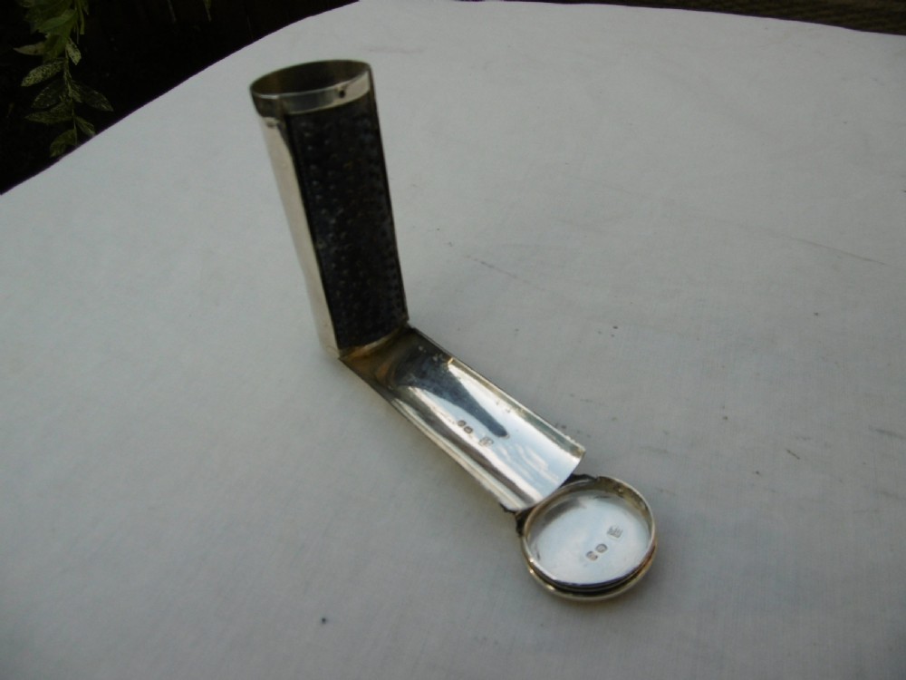 An open Victorian cylindrical silver nutmeg grater displaying an internal steel rasp and hallmarked silver fold-out interior.