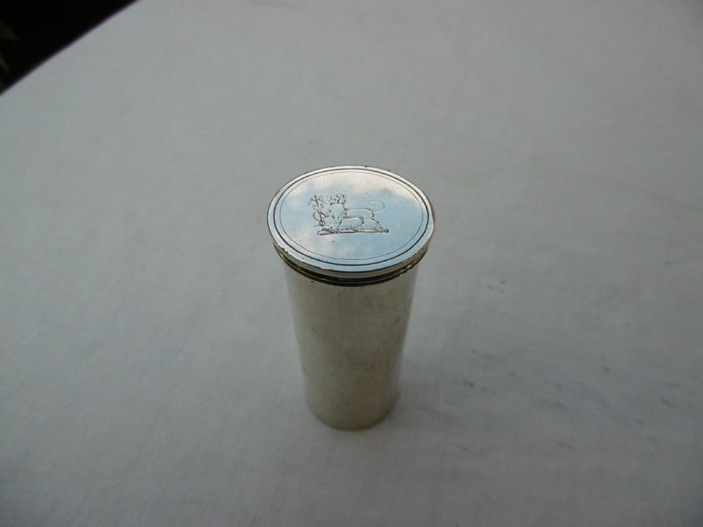 An open Victorian cylindrical silver nutmeg grater displaying an internal steel rasp and hallmarked silver fold-out interior. View II