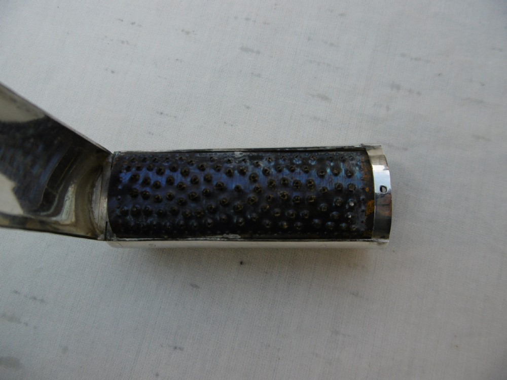 An open Victorian cylindrical silver nutmeg grater displaying an internal steel rasp and hallmarked silver fold-out interior. View IV
