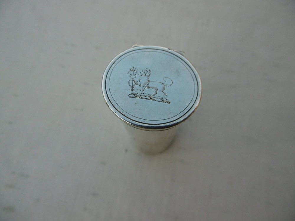 An open Victorian cylindrical silver nutmeg grater displaying an internal steel rasp and hallmarked silver fold-out interior. View V