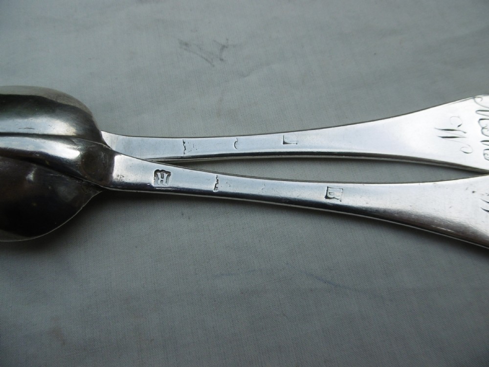 A pair of 1706 Scottish Queen Anne sterling silver dognose tablespoons featuring rat-tail bowl supports and engraved initials on the handle terminals. View III