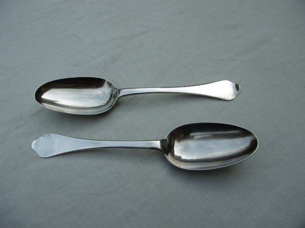 A pair of 1706 Scottish Queen Anne sterling silver dognose tablespoons featuring rat-tail bowl supports and engraved initials on the handle terminals. View VI