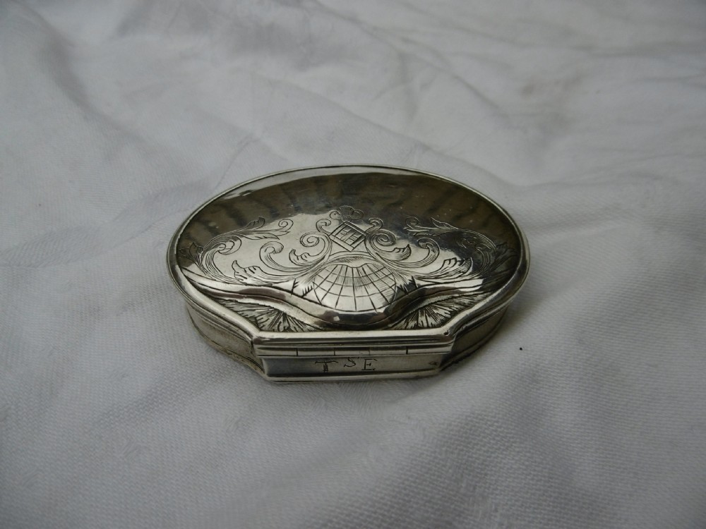 An eighteenth-century silver shell-shaped snuff box featuring hand-engraved scrollwork across the hinged lid. View II