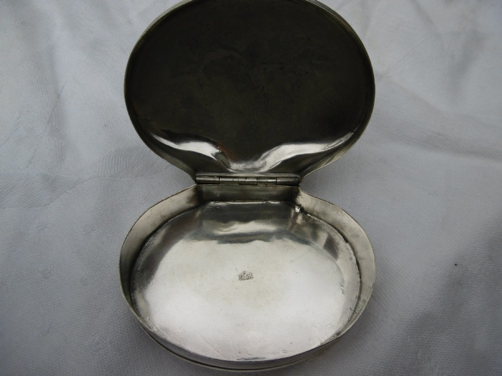 An eighteenth-century silver shell-shaped snuff box featuring hand-engraved scrollwork across the hinged lid. View IV