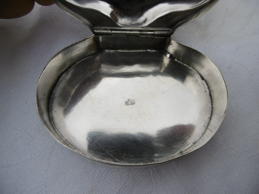 An eighteenth-century silver shell-shaped snuff box featuring hand-engraved scrollwork across the hinged lid. View V