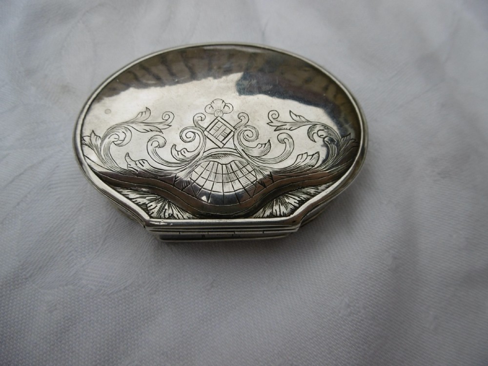 An eighteenth-century silver shell-shaped snuff box featuring hand-engraved scrollwork across the hinged lid. View VI