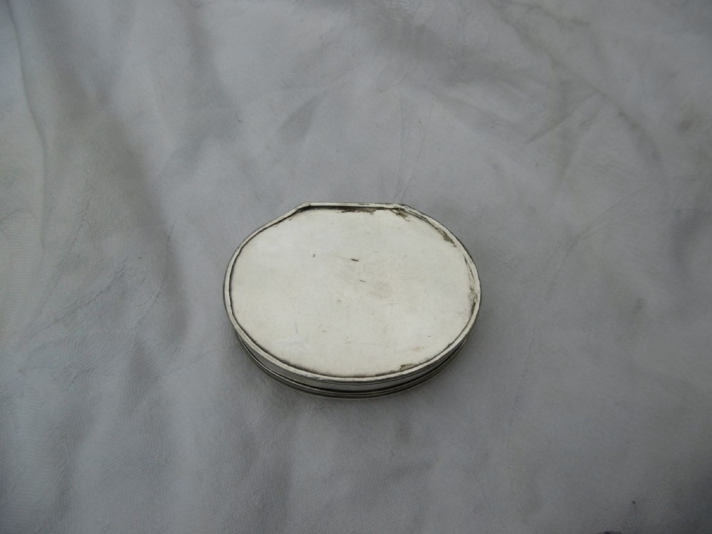 An eighteenth-century silver shell-shaped snuff box featuring hand-engraved scrollwork across the hinged lid. View VII
