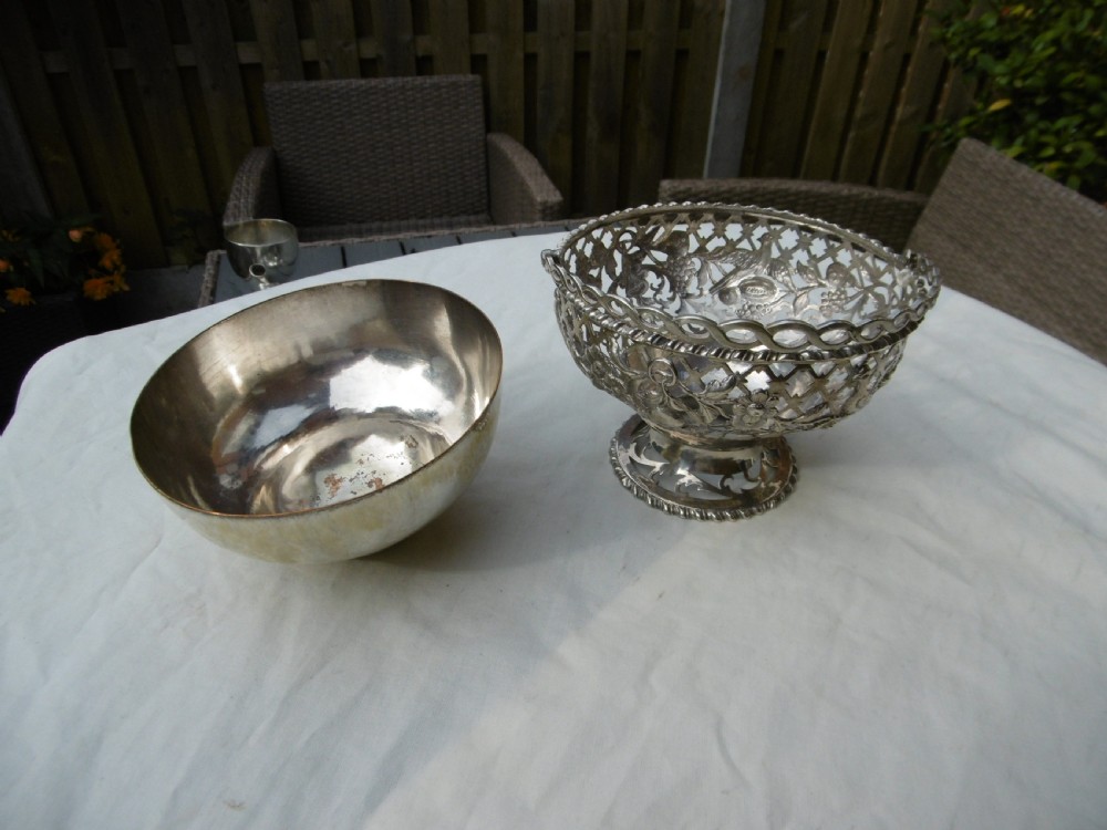 An 18th-century Irish Georgian sterling silver basket featuring pierced lattice work, floral motifs, a pedestal base, and an arched swing handle. View II
