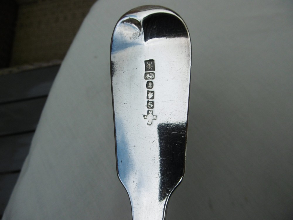 A pair of Georgian sterling silver soup ladles featuring Fiddle pattern handles engraved with crests and deep round silver bowls. View IV