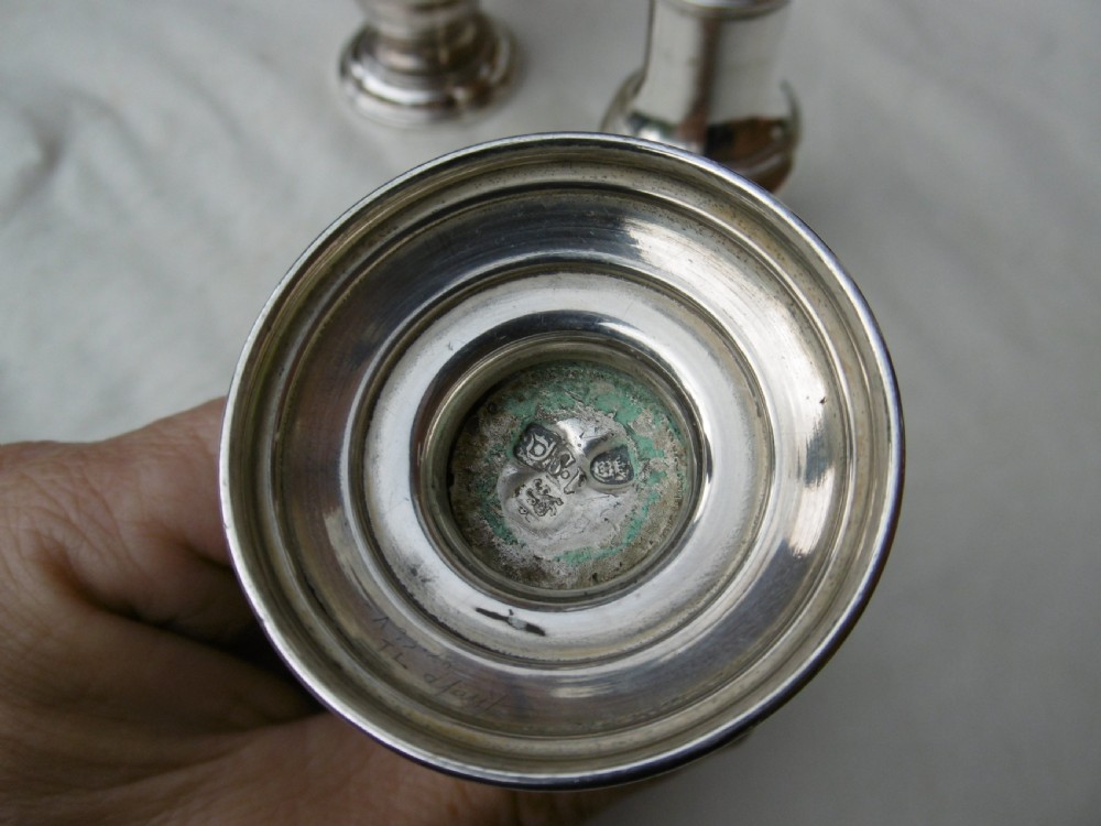 An 18th-century Georgian sterling silver Warwick cruet frame holding silver casters and cut glass bottles set upon shell-form feet. View VIII