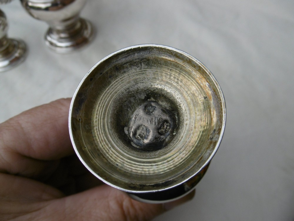 An 18th-century Georgian sterling silver Warwick cruet frame holding silver casters and cut glass bottles set upon shell-form feet. View X