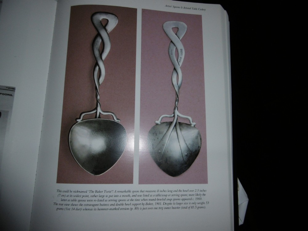 An Arts and Crafts sterling silver spoon with a twisted Celtic knot handle and a planished heart-shaped bowl. View IV