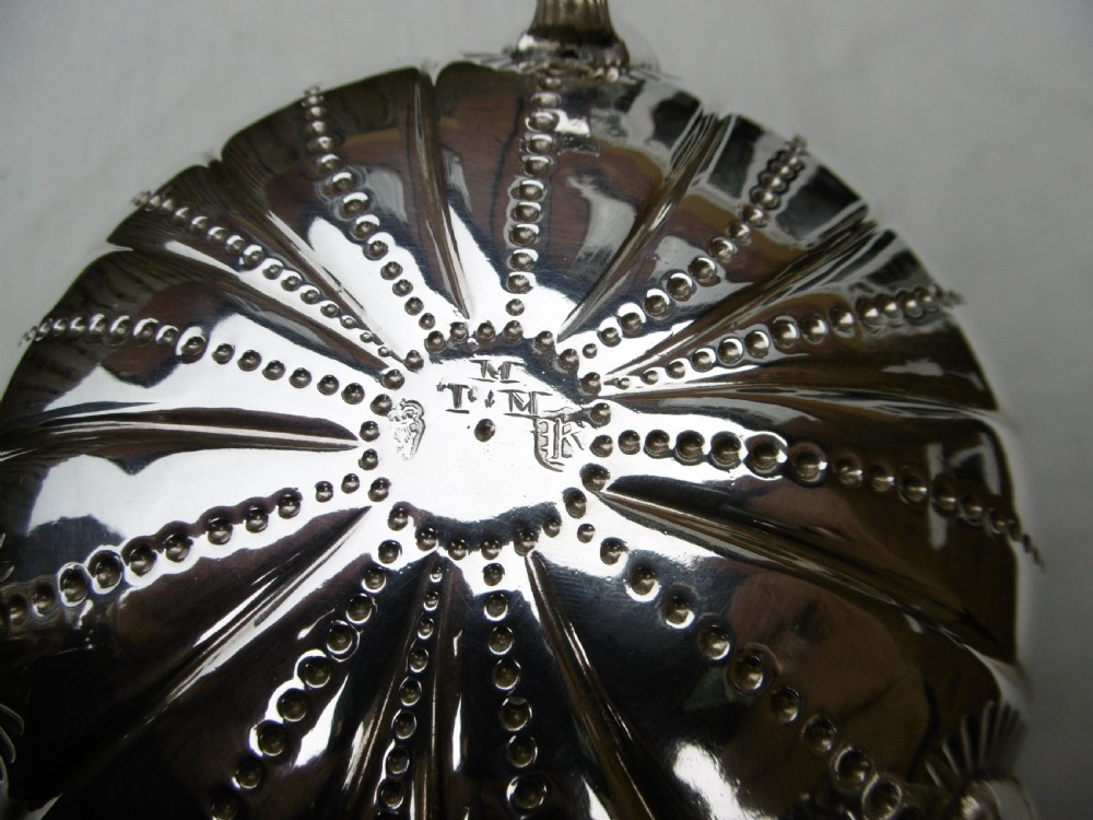 An antique George II sterling silver footed bowl featuring fluted sides, bead details, and shell-motif legs. View II