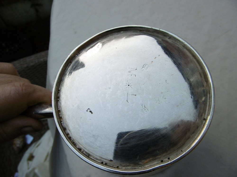 A George I silver brandy pan featuring a flared rim, plain cylindrical body, and a long turned dark wood handle. View III