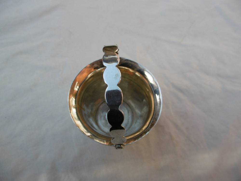 A George II sterling silver cream pail with a reeded bucket body and an overhead swing handle. View IV