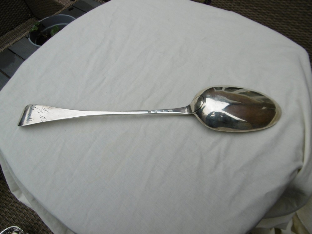 An 18th-century Georgian sterling silver hash spoon featuring a long tapered stem and a deep oval serving bowl. View II
