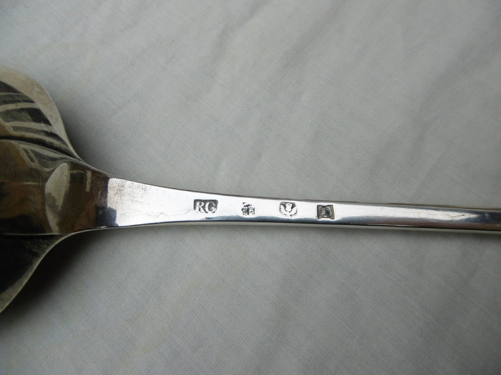 An 18th-century Georgian sterling silver hash spoon featuring a long tapered stem and a deep oval serving bowl. View III