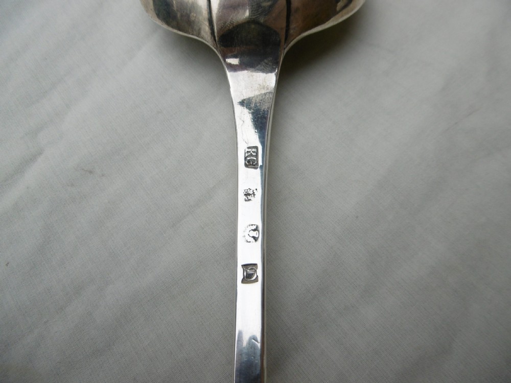 An 18th-century Georgian sterling silver hash spoon featuring a long tapered stem and a deep oval serving bowl. View IV