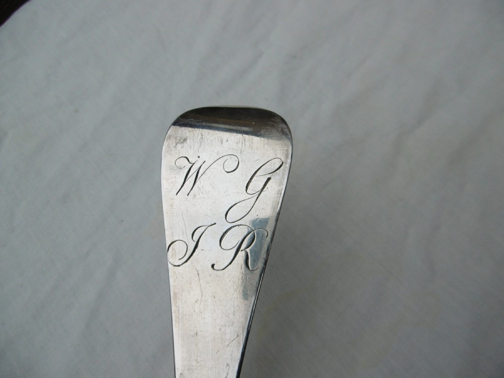An 18th-century Georgian sterling silver hash spoon featuring a long tapered stem and a deep oval serving bowl. View V