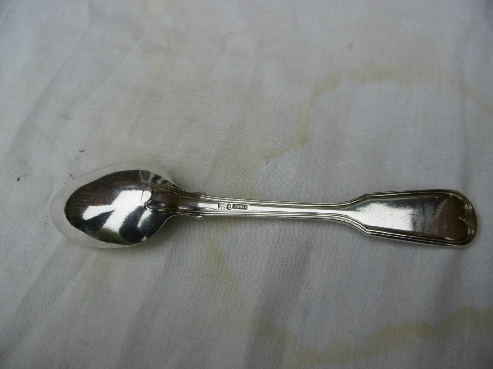 A Georgian sterling silver tablespoon featuring an engraved heraldic crest on the stem handle and an oval polished bowl. View IV