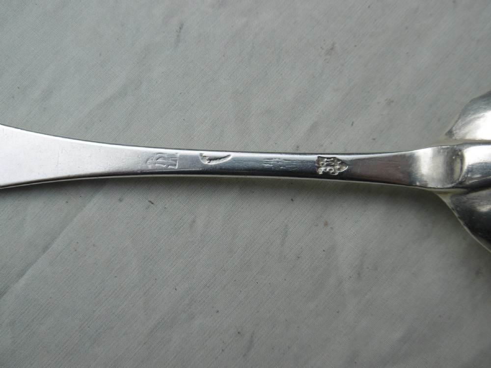 An antique 1702 Queen Anne silver dognose spoon with engraved initials on the handle and a rat-tail join on the reverse of the oval bowl. View II