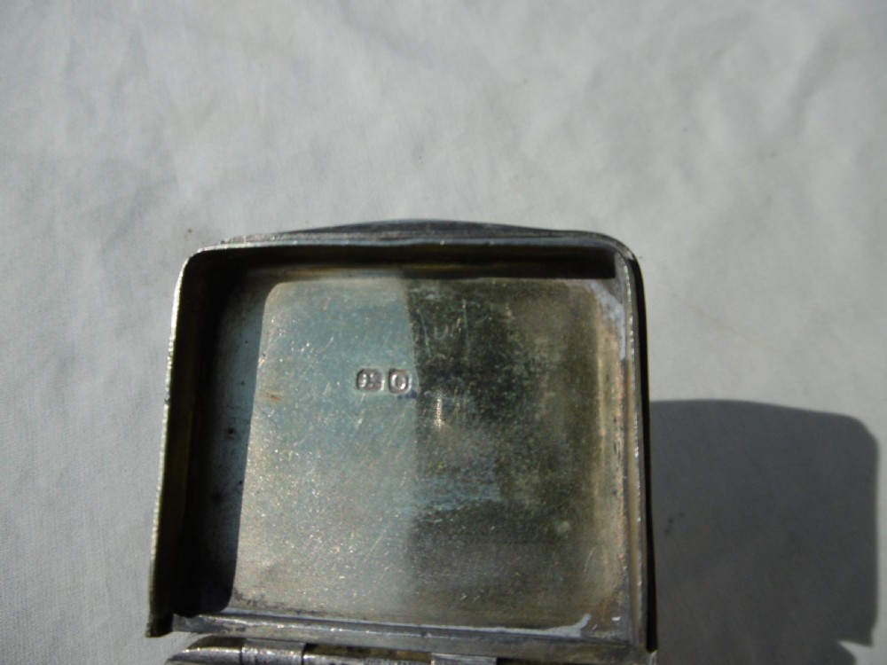 An antique sterling silver double-lidded snuff box featuring reeded linear engraving and interior silver hallmarks. View V