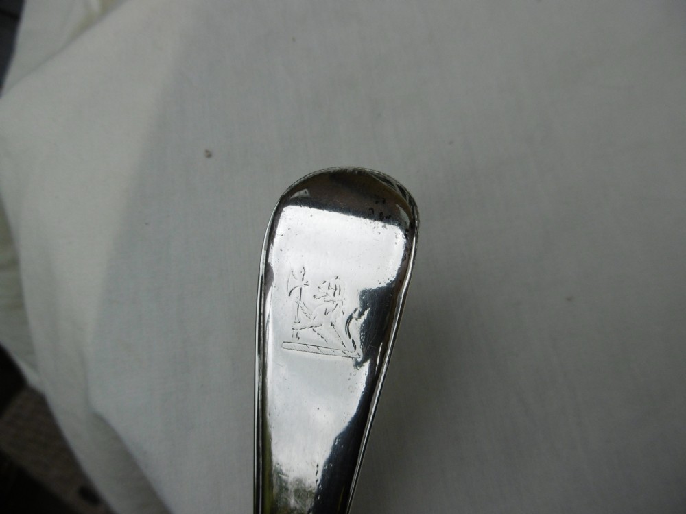 A Georgian sterling silver soup ladle featuring a long curved stem, a circular bowl, and official assay hallmarks near the terminal. View III