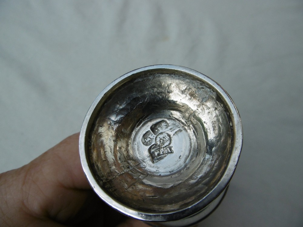 A George I sterling silver baluster-shaped caster featuring a decorative hand-pierced domed lid with a finial top. View II