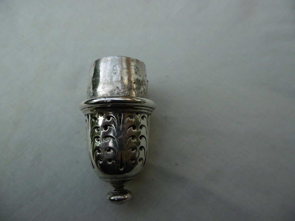 A George I sterling silver baluster-shaped caster featuring a decorative hand-pierced domed lid with a finial top. View III