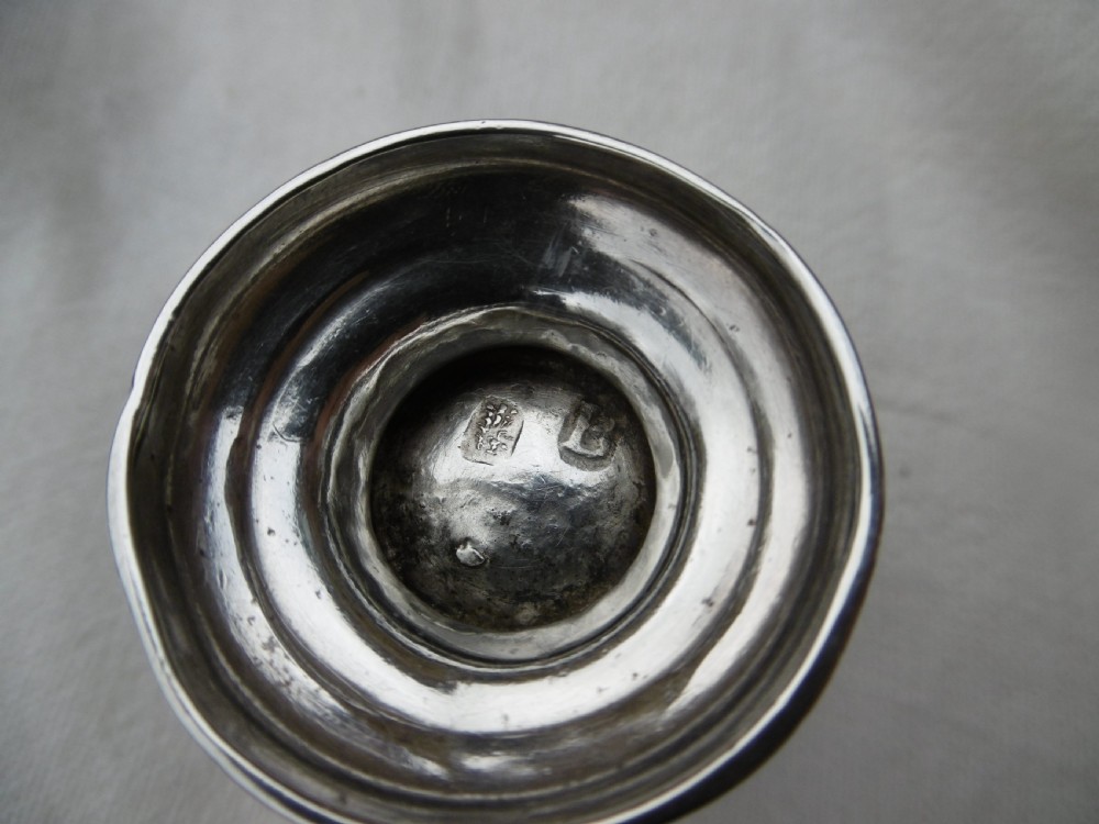 A small George I sterling silver tot cup featuring a flared rim and a circular molded pedestal base. View II
