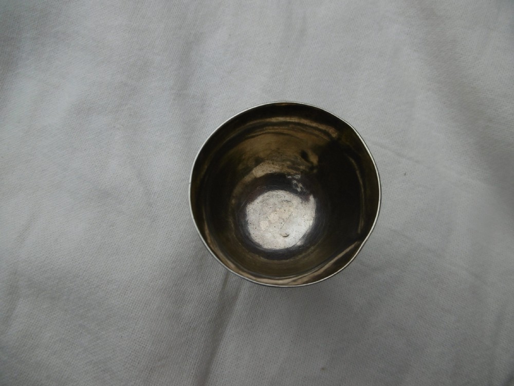 A small George I sterling silver tot cup featuring a flared rim and a circular molded pedestal base. View III