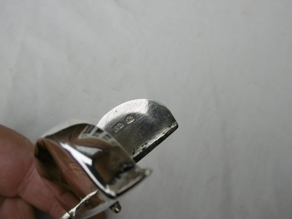 A Georgian sterling silver scissor-style candle snuffer featuring a small rectangular wick box, pointed tip, and shaped handle loops. View IV