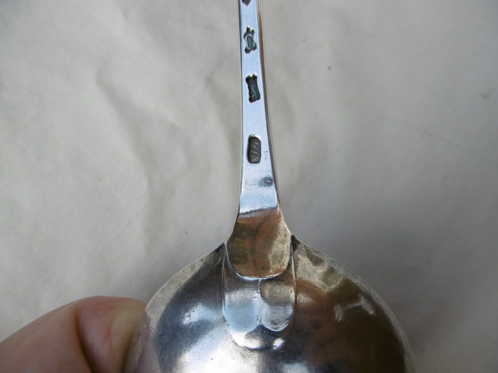 A mid-18th-century Georgian sterling silver stuffing spoon showing maker hallmarks along the slender stem and a polished oval bowl. View III