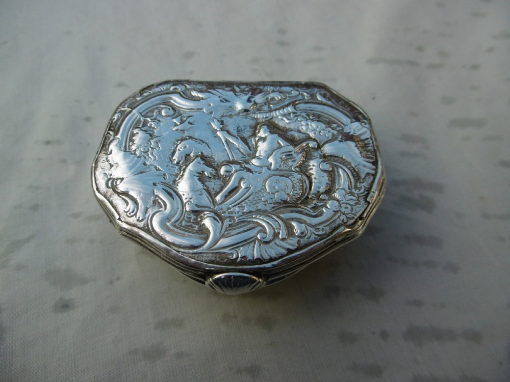 An eighteenth-century silver snuff box featuring an embossed mythological relief of Neptune on the hinged lid.