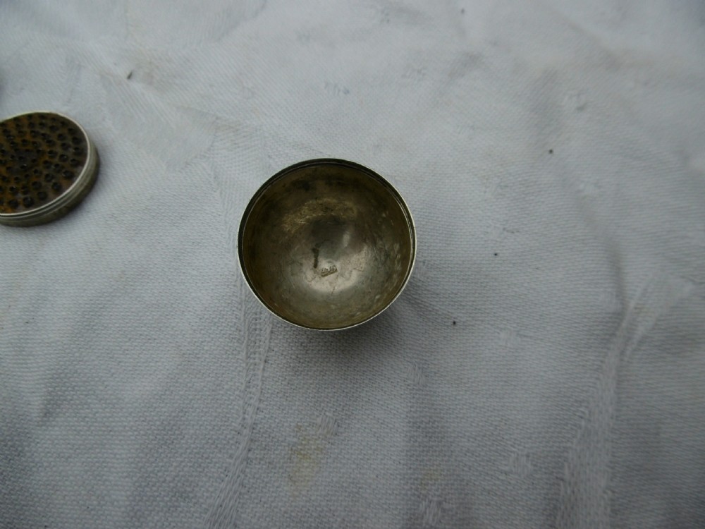 A three-piece antique Georgian sterling silver acorn-shaped nutmeg grater shown unscrewed alongside its circular steel grater plate. View II