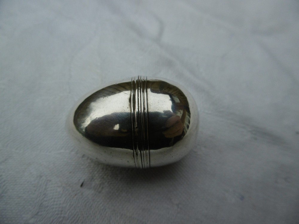A three-piece antique Georgian sterling silver acorn-shaped nutmeg grater shown unscrewed alongside its circular steel grater plate. View IV