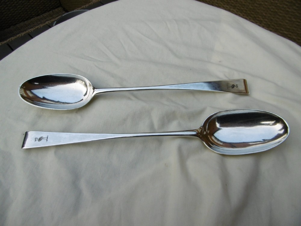 A pair of 18th-century Irish sterling silver basting spoons with hooked terminals presented inside a black velvet and silk lined case. View II