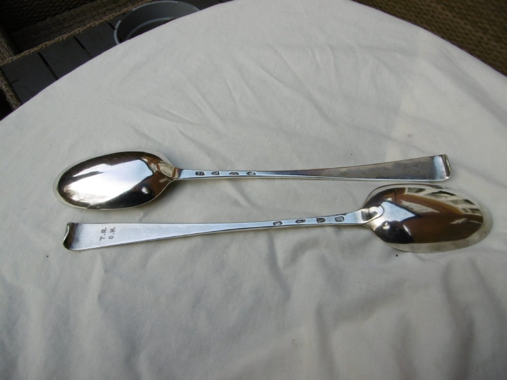 A pair of 18th-century Irish sterling silver basting spoons with hooked terminals presented inside a black velvet and silk lined case. View III