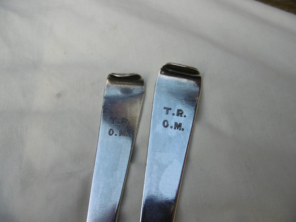 A pair of 18th-century Irish sterling silver basting spoons with hooked terminals presented inside a black velvet and silk lined case. View VI