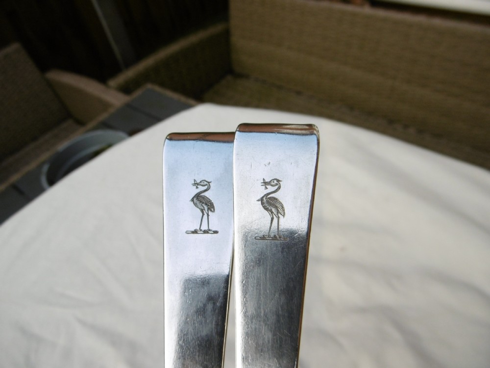 A pair of 18th-century Irish sterling silver basting spoons with hooked terminals presented inside a black velvet and silk lined case. View VII