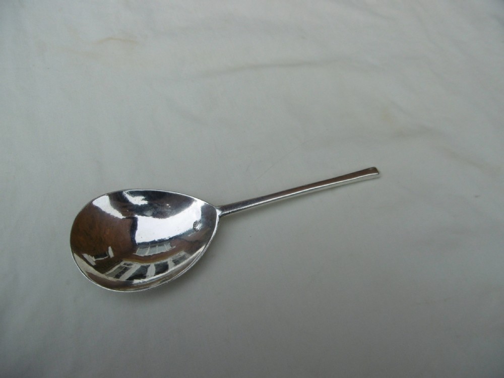 A 17th-century sterling silver slip top spoon displaying a wide fig-shaped bowl and a tapered hexagonal stem.