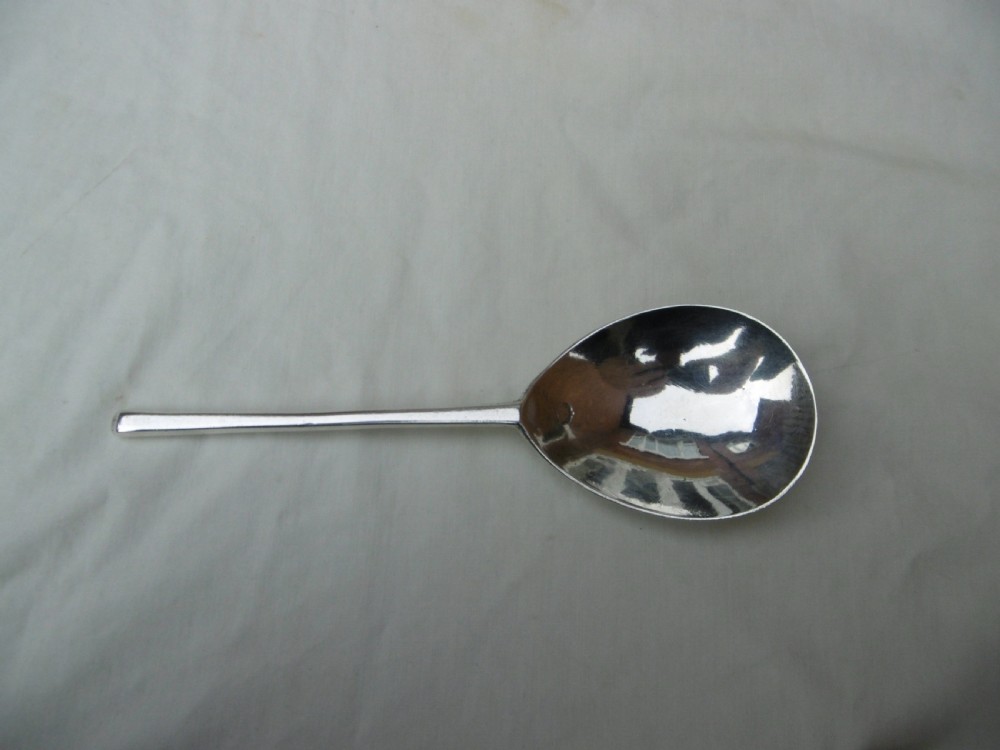 A 17th-century sterling silver slip top spoon displaying a wide fig-shaped bowl and a tapered hexagonal stem. View II